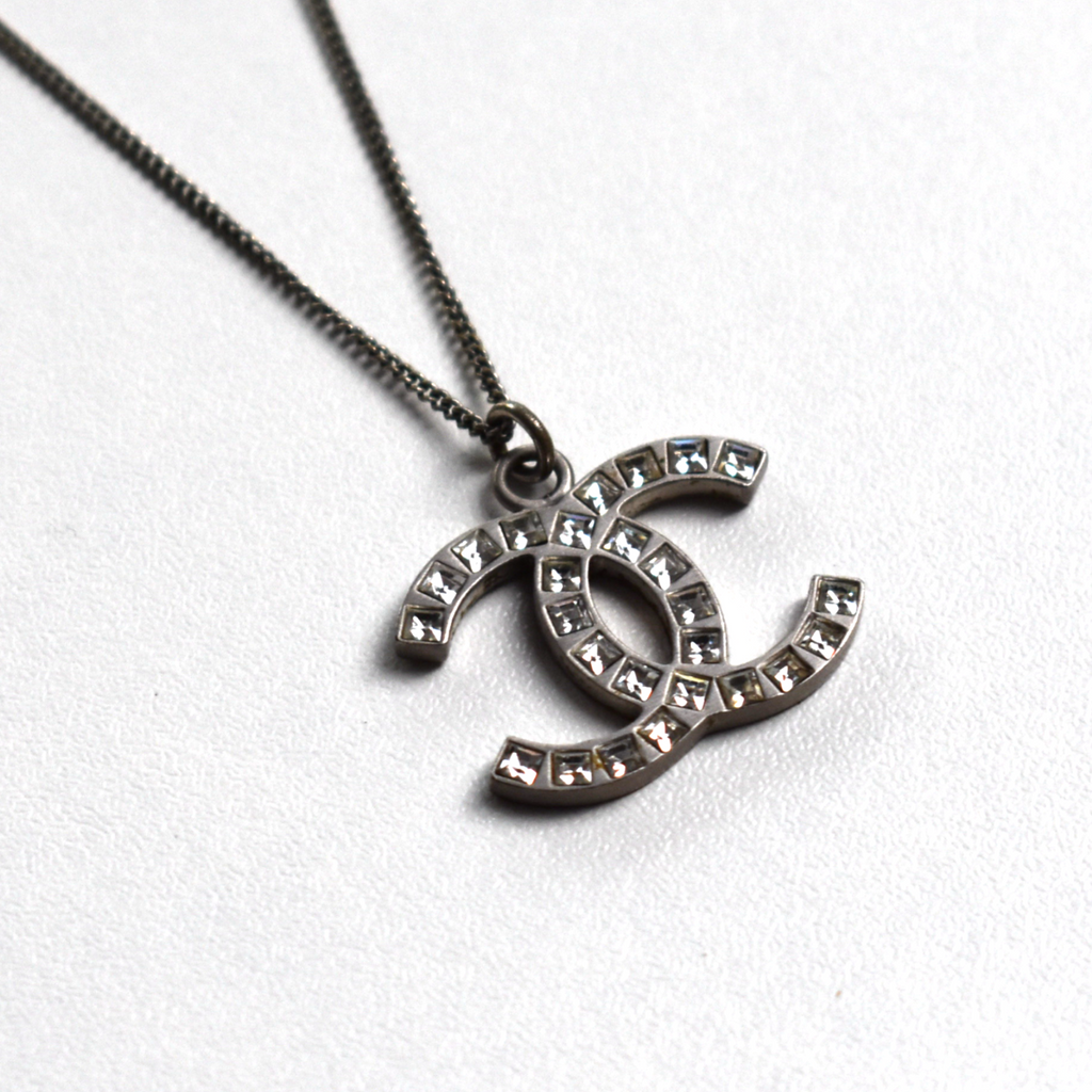 Silver Chanel CC rhinestone necklace pendant, angled front view