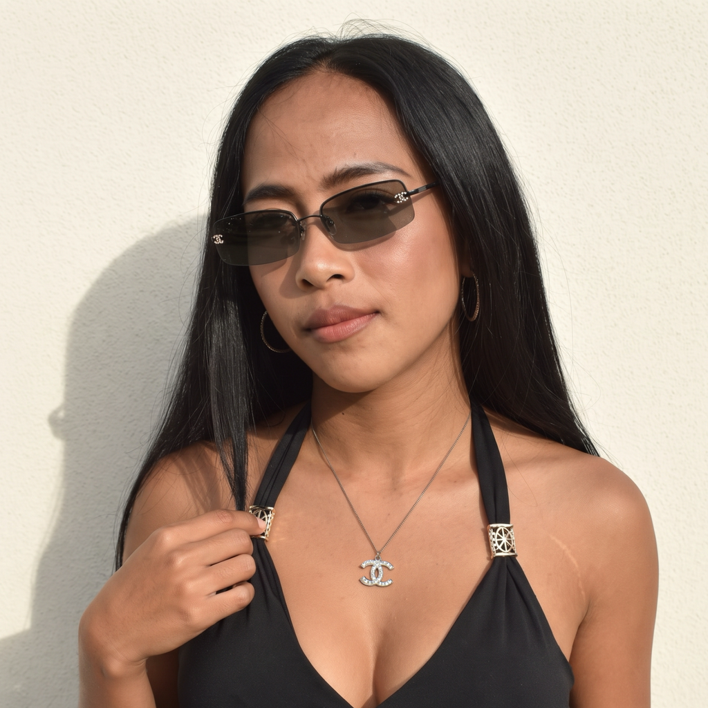 Model wearing silver Chanel CC rhinestone necklace, wider view