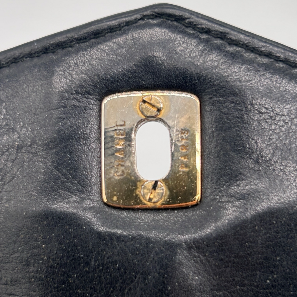 Engraved detail on vintage black Chanel Turnlock belt bag