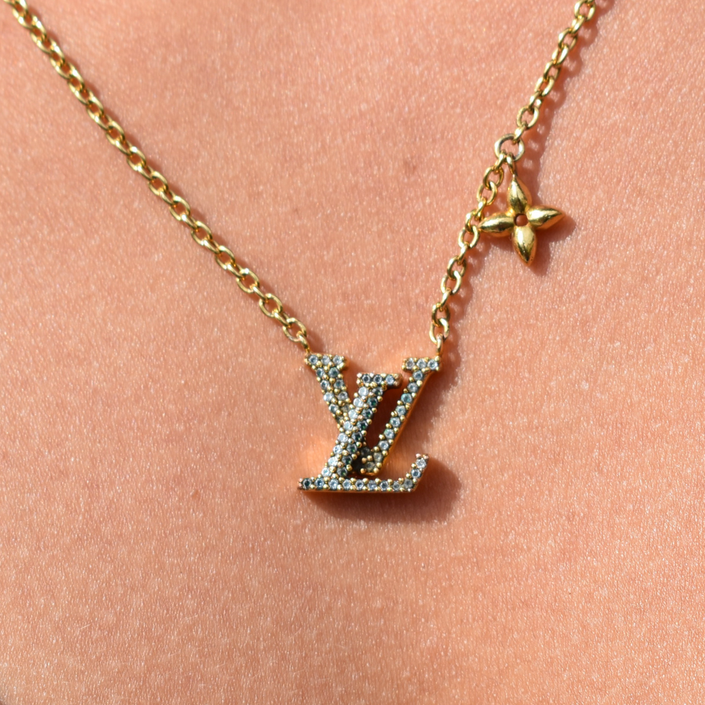 Close-up of model wearing gold Louis Vuitton Iconic rhinestone necklace