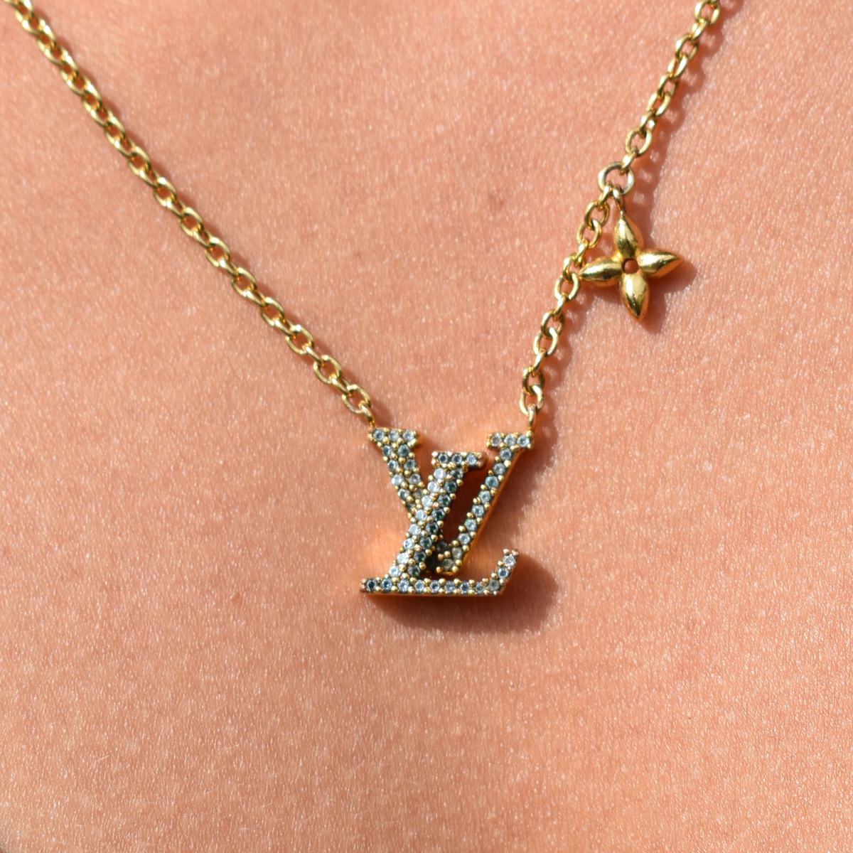 Close-up of model wearing gold Louis Vuitton Iconic rhinestone necklace