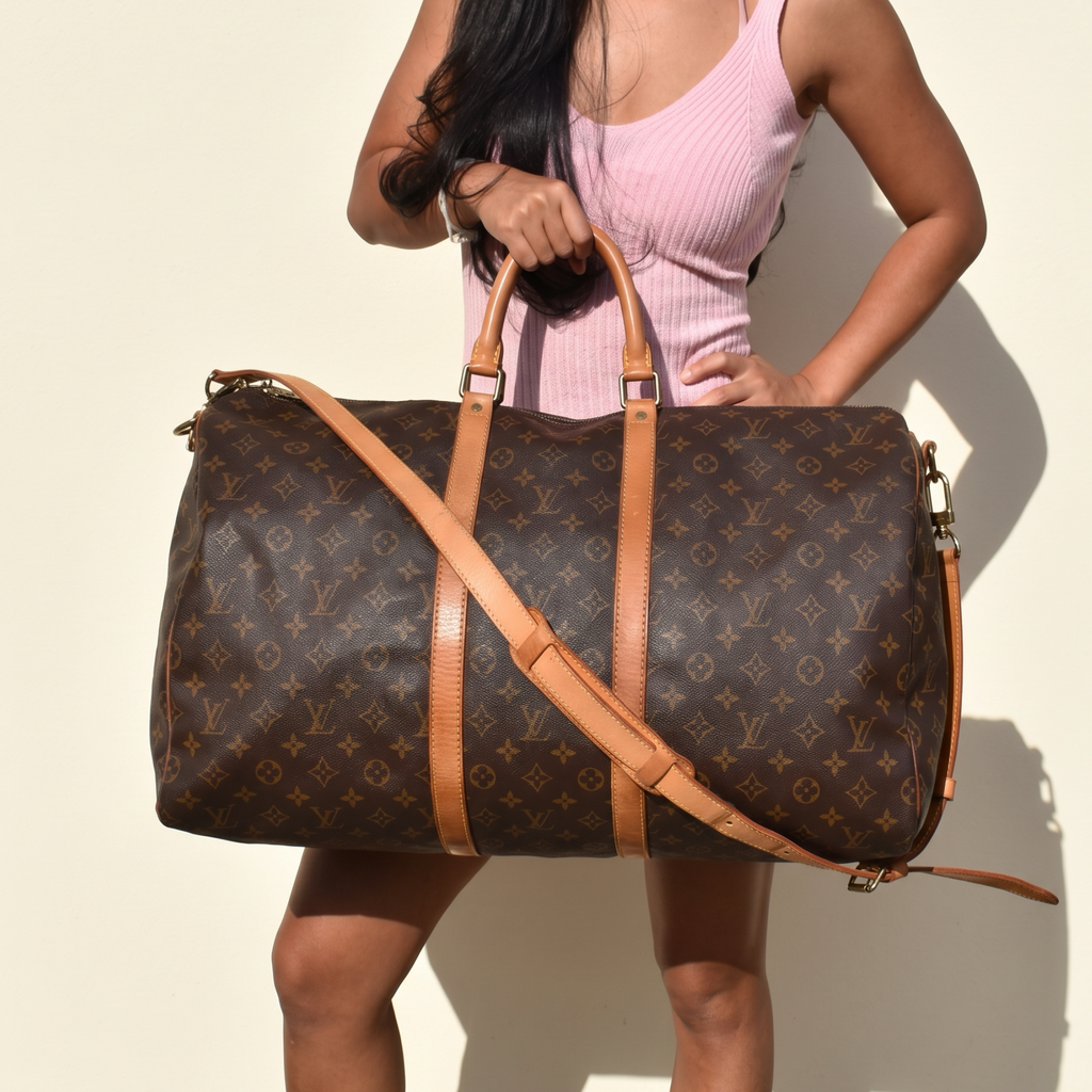 Close-up of model with vintage Louis Vuitton Bandoulière 55 holdall, front view